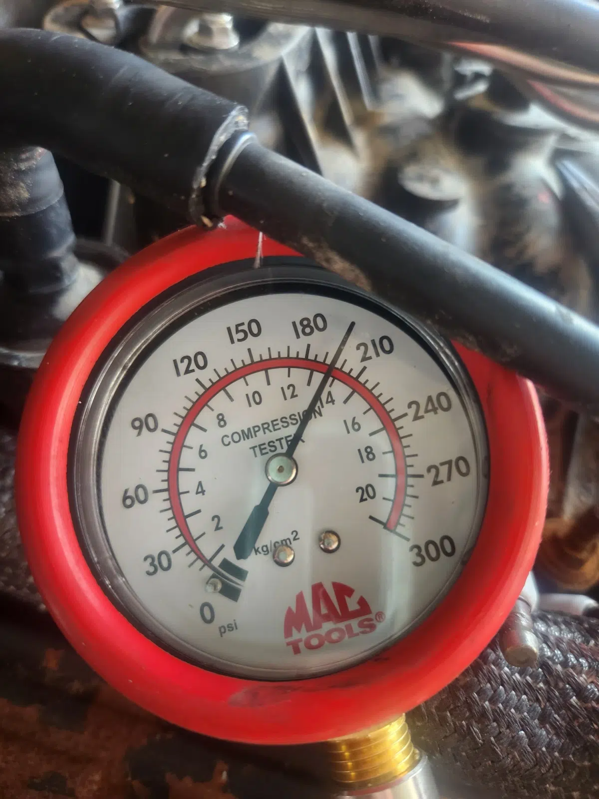 Compression tester gauge reading during a small engine test — Tri County Small Engine Repair in Cape Coral
